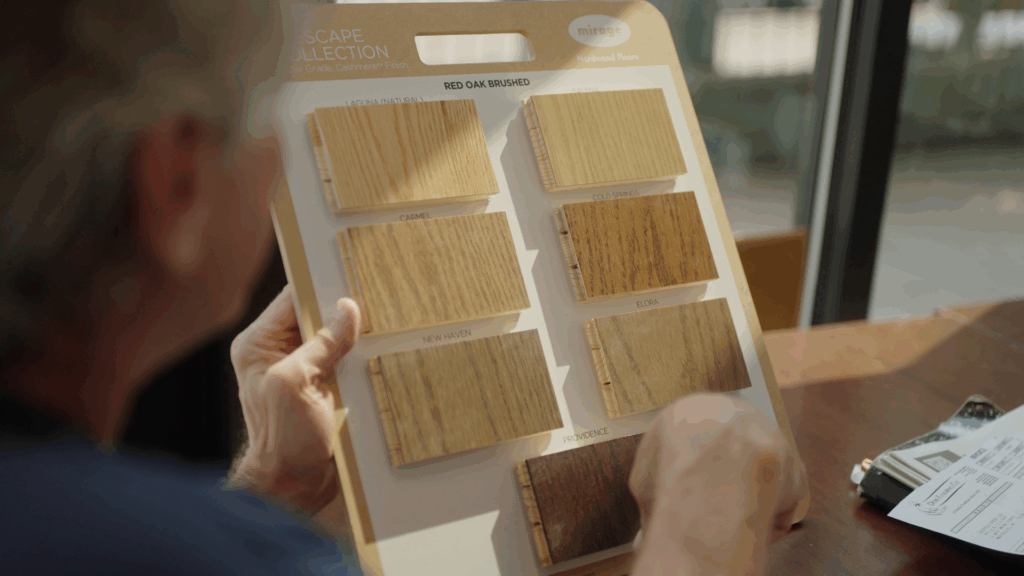 Customer reviewing hardwood flooring stain and species samples