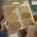 Customer reviewing hardwood flooring stain and species samples